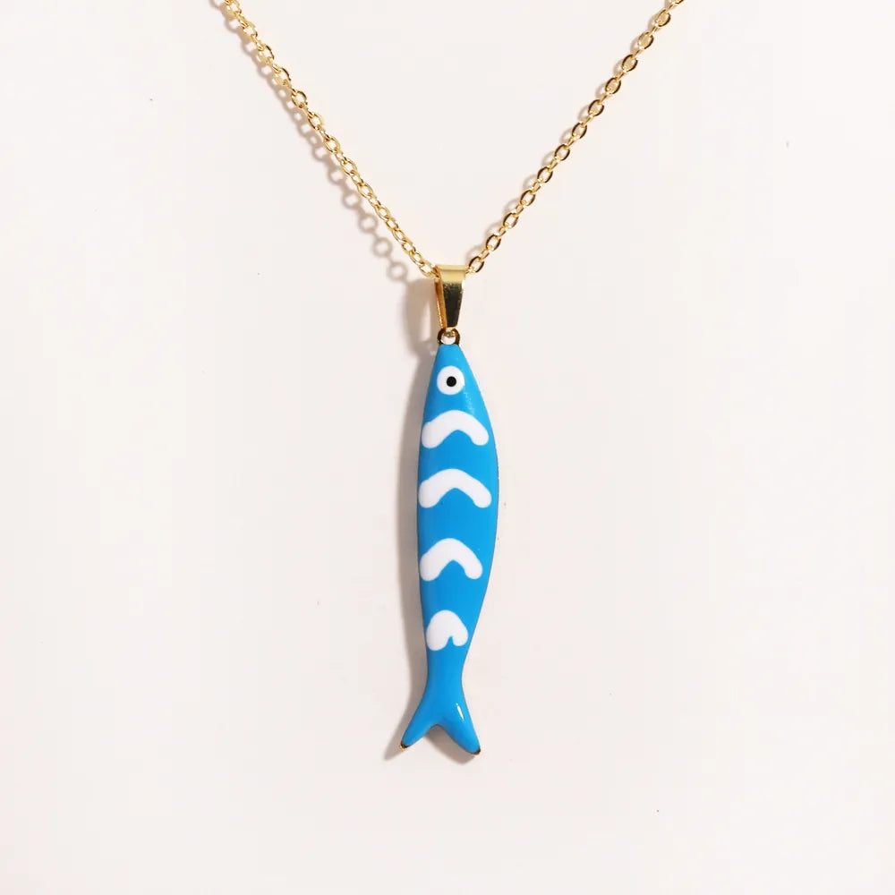 Gold necklace with a coloured enamel fish pendant inspired by Mediterranean coastal style