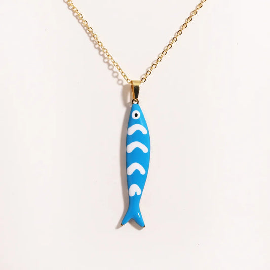Gold necklace with a coloured enamel fish pendant inspired by Mediterranean coastal style